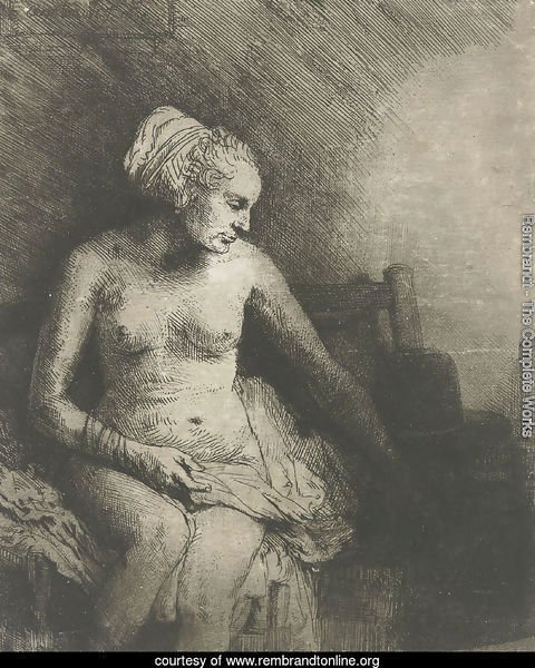 A woman at the bath with a hat beside her